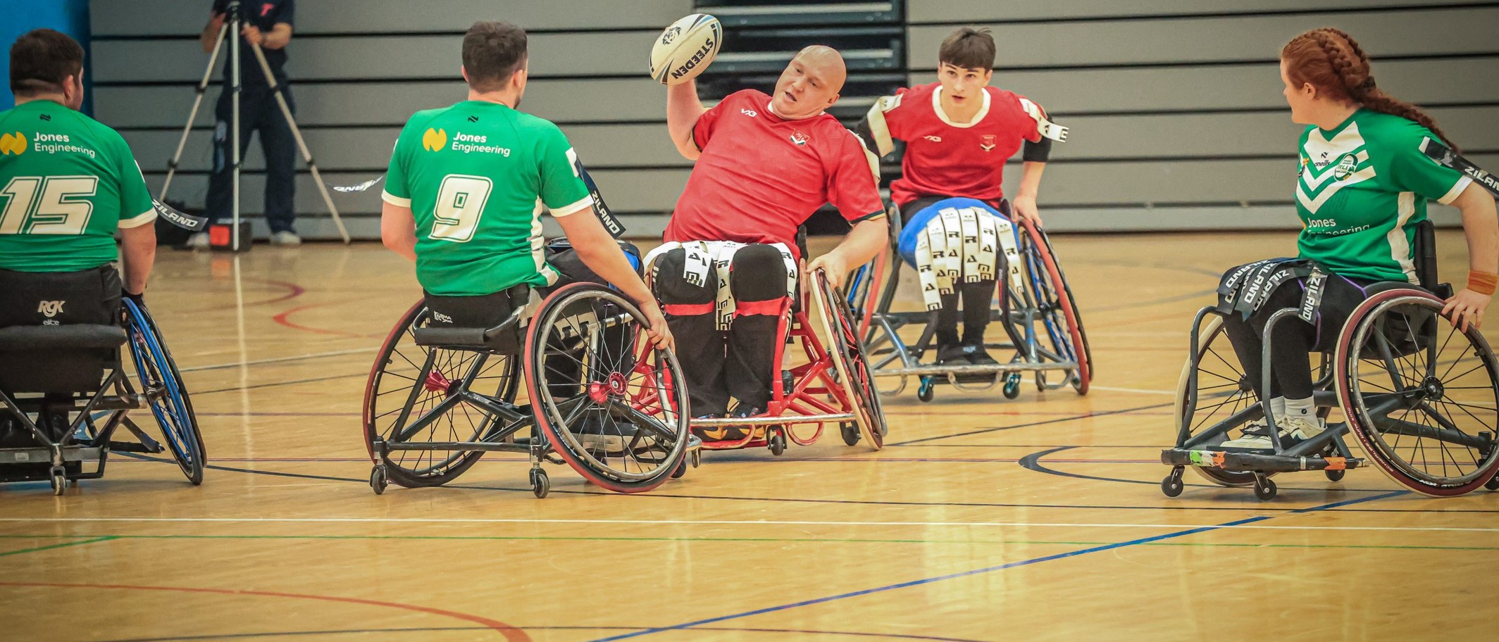 Wales wheelchair rugby league players in red shirts compete against Ireland in green