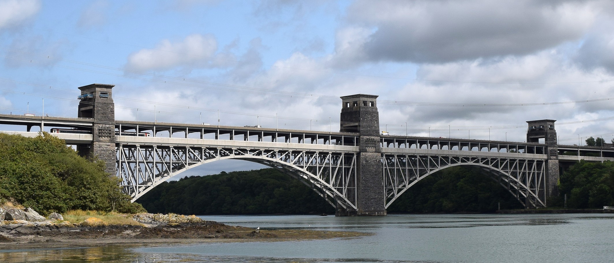 The Britannia Bridge over the Menai Strait, which carries the A55. Photo: Bill Harrison, CC BY-SA 2.0, via Geograph (geograph.org.uk/photo/7372220) and Wikimedia Commons