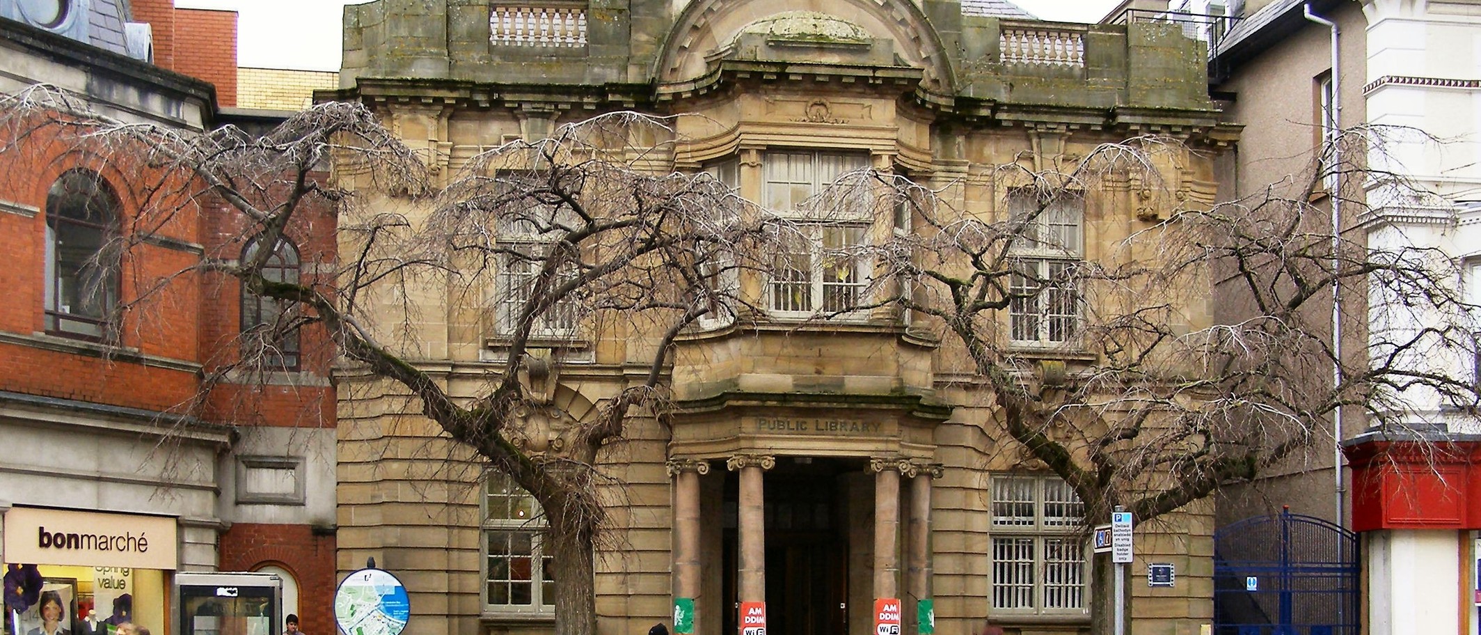 Archive: Llandudno Library on Mostyn Street, 18 February 2010, one of the announced drop-in venues. David Dixon / Geograph and Wikimedia Commons, CC BY-SA 2.0; cropped.