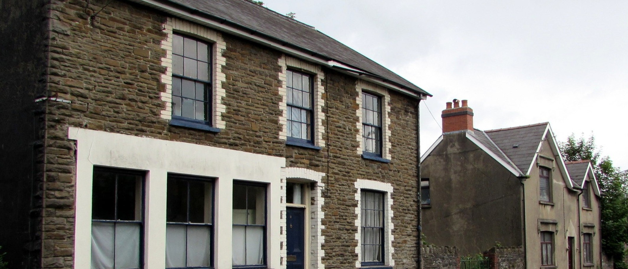 Stone houses on Caerphilly Road in Ystrad Mynach, in the Caerphilly county borough the school serves. Photo: Jaggery, CC BY-SA 2.0, via Geograph (geograph.org.uk/photo/6171404) and Wikimedia Commons