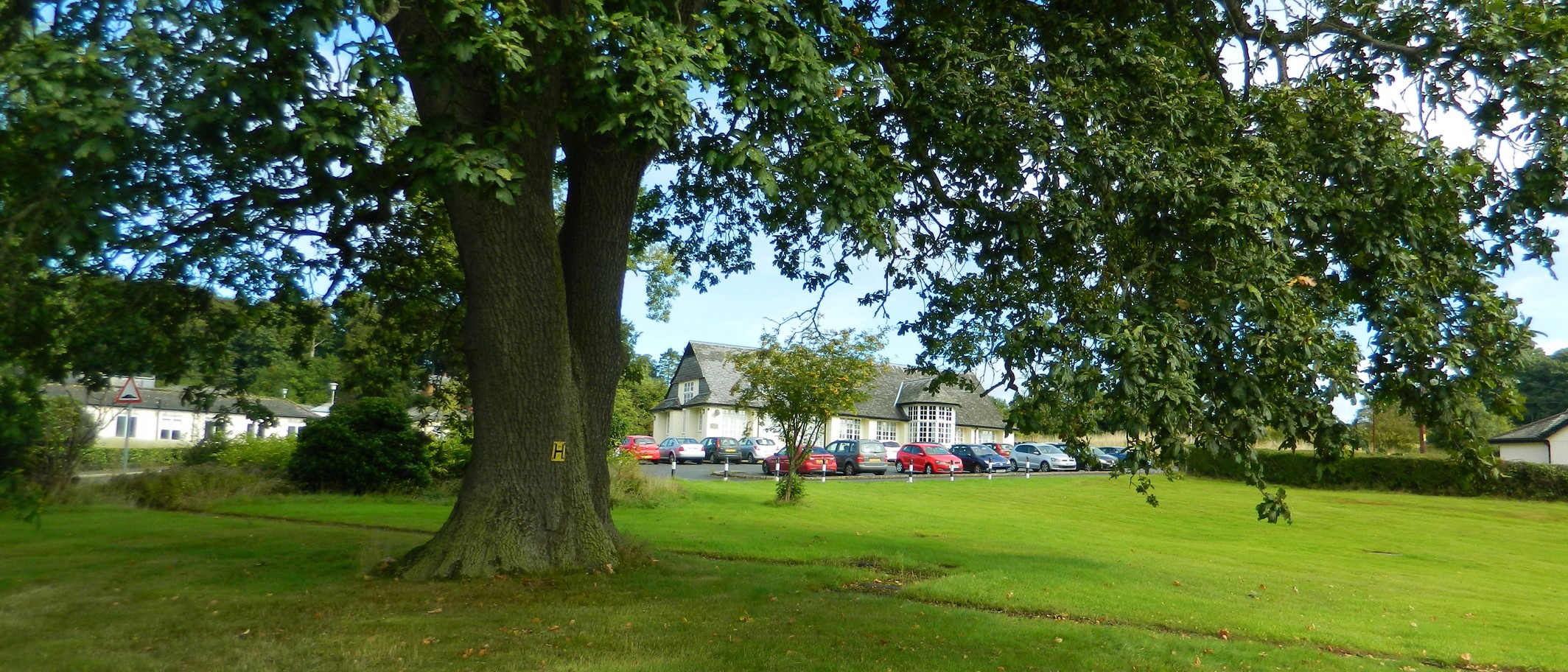 Archive view of Bronllys Hospital and its grounds in September 2013, used as location context for the Powys consultation proposals. Photo: John Lord, CC BY-SA 2.0, via Geograph (geograph.org.uk/photo/3651679) and Wikimedia Commons