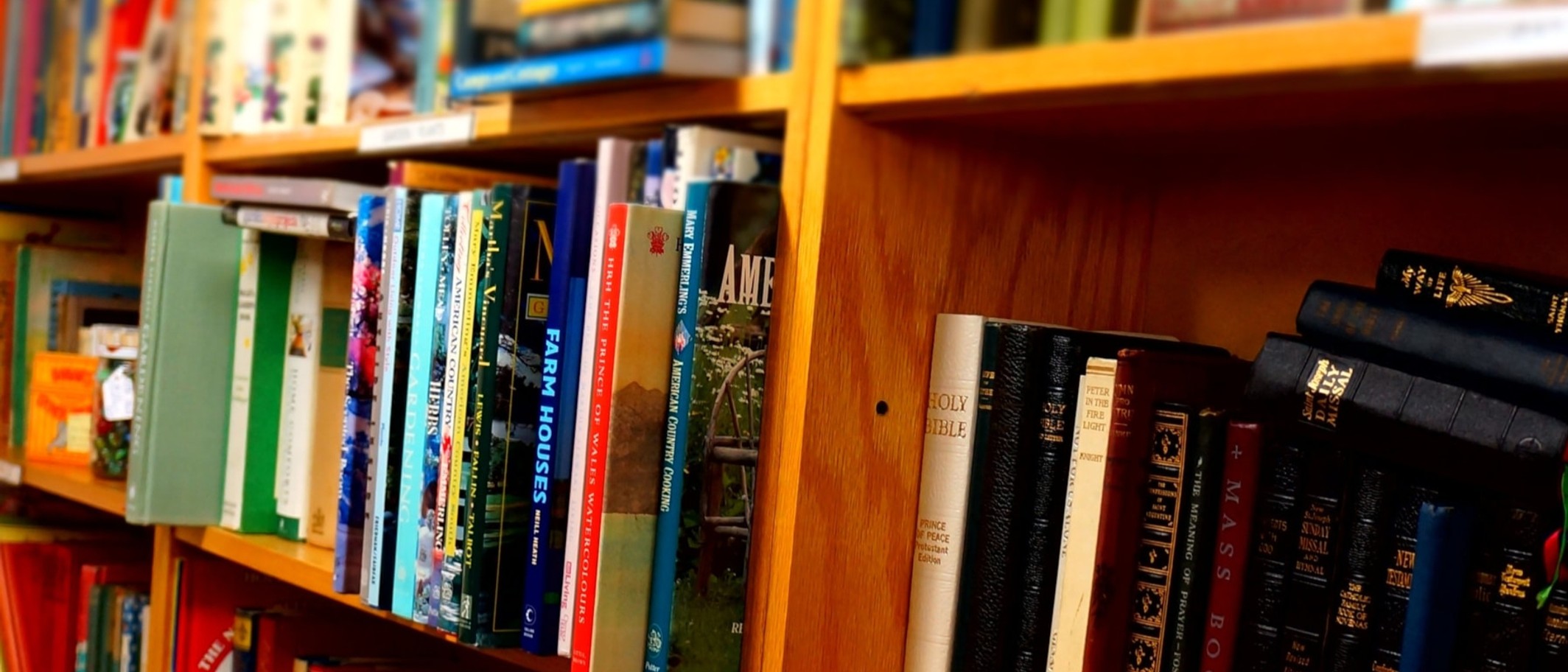 Illustrative books photograph supplied with the Welsh Government release. The image was first published in its press library in February 2025; it does not identify a funded project. Welsh Government, Open Government Licence v3.0; cropped.