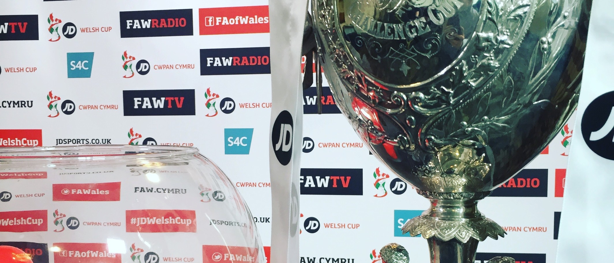The men’s Welsh Cup trophy beside draw balls. Archive photo: Mc2810, CC BY-SA 4.0, via Wikimedia Commons.