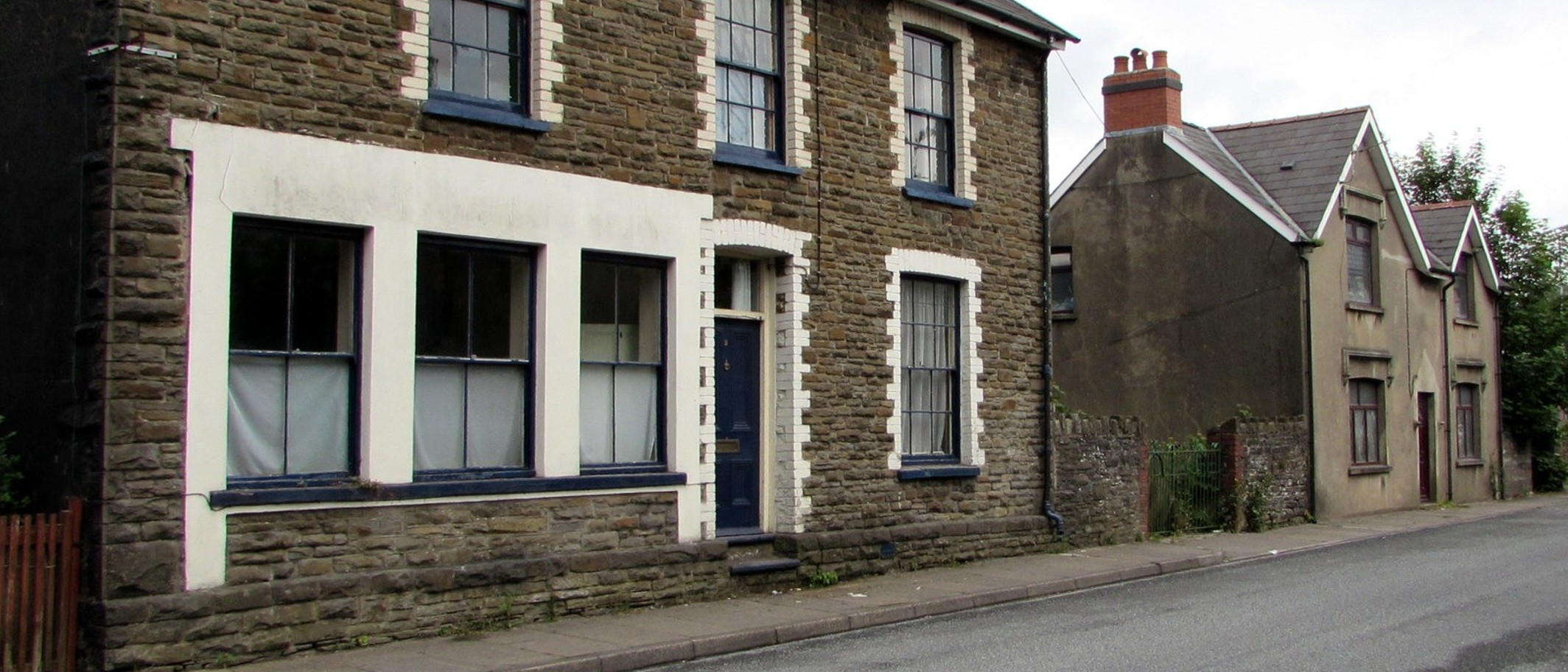 Archive photograph: houses on Caerphilly Road, Ystrad Mynach, in June 2019. General housing context; these homes are not identified as part of the survey. Photo: Jaggery, CC BY-SA 2.0; cropped.