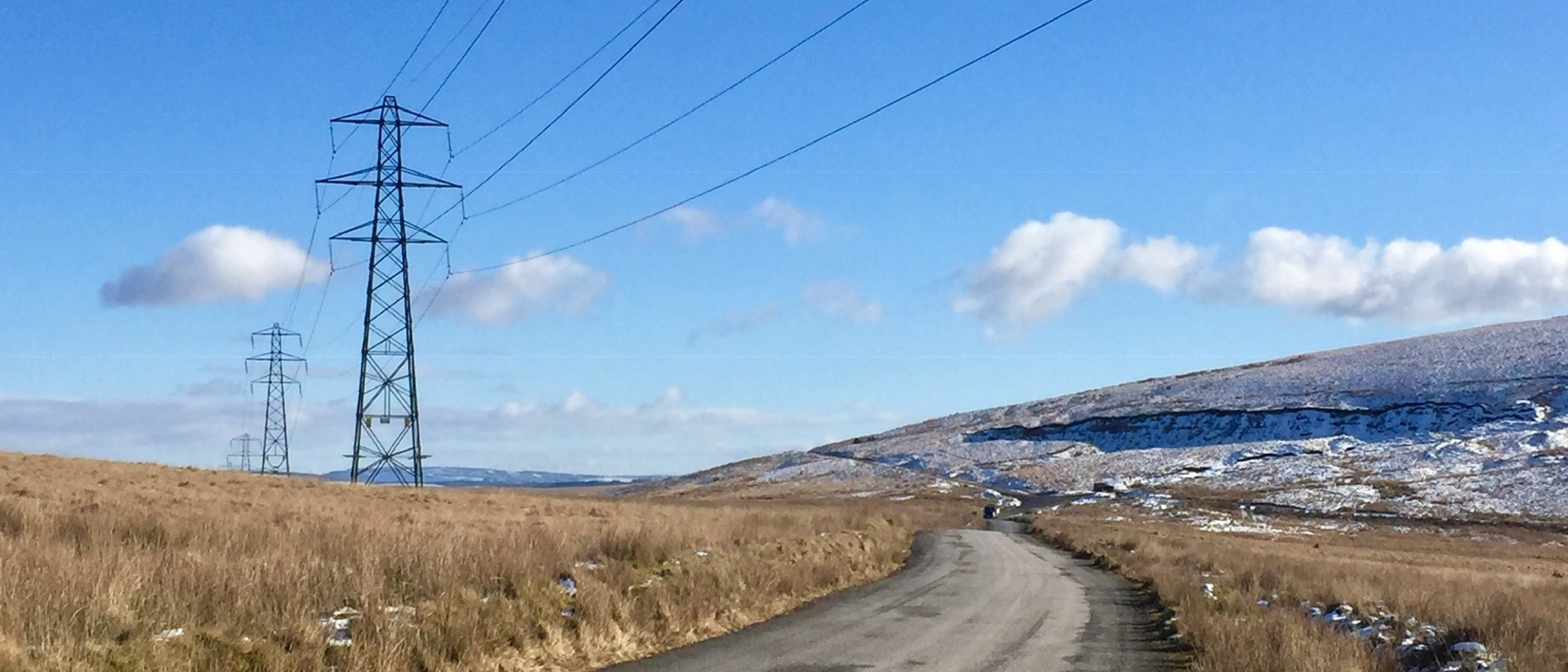 Archive: electricity pylons at Mynydd y Betws, Carmarthenshire, 2 February 2019. Alan Hughes, CC BY-SA 2.0. Existing infrastructure shown for context.
